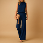 Elegant wide-leg jumpsuit for women with round neckline and mid-waist fit, ideal for work or formal occasions.