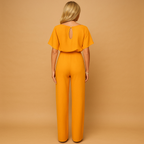 High-waisted women’s jumpsuit with lace-up detail and flowing fit, ideal for work, evening wear, and stylish casual looks.