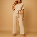 High-waisted women’s jumpsuit with lace-up detail and flowing fit, ideal for work, evening wear, and stylish casual looks.