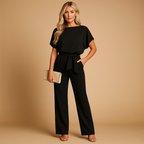 High-waisted women’s jumpsuit with lace-up detail and flowing fit, ideal for work, evening wear, and stylish casual looks.