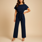 High-waisted women’s jumpsuit with lace-up detail and flowing fit, ideal for work, evening wear, and stylish casual looks.