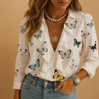Women’s ruffle blouse with butterfly print and long sleeves, offering a light tailored fit and feminine style for all-day wear.