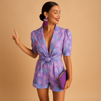 Short summer jumpsuit for women with playful print and waist belt, perfect for warm weather and stylish evenings.