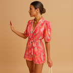 Short summer jumpsuit for women with playful print and waist belt, perfect for warm weather and stylish evenings.