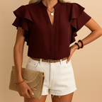 Women’s sleeveless elegant blouse with tailored fit, perfect for work, casual looks, or evening wear in classic tones.