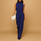 Elegant women’s jumpsuit with halter neckline, wide legs, and bow detail – perfect for parties, dinners, and evenings out.